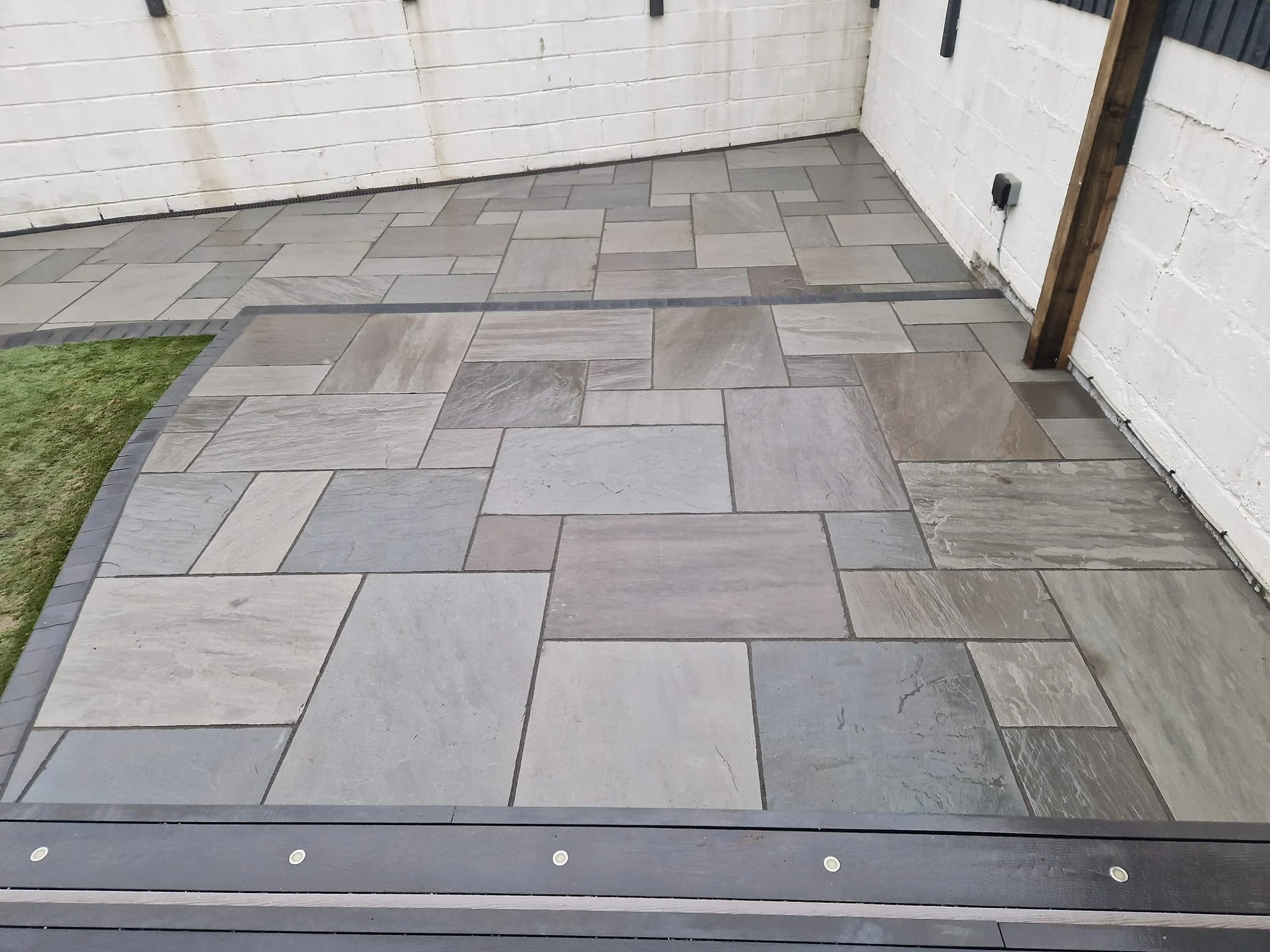 Grey sandstone patio with a charcoal border