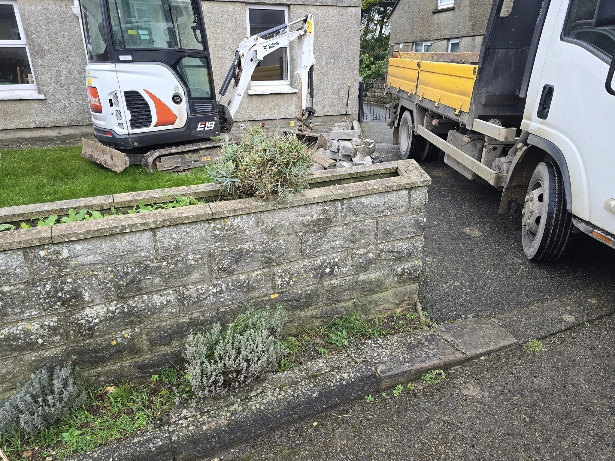 Mini digger and tipper truck on a groundwork job
