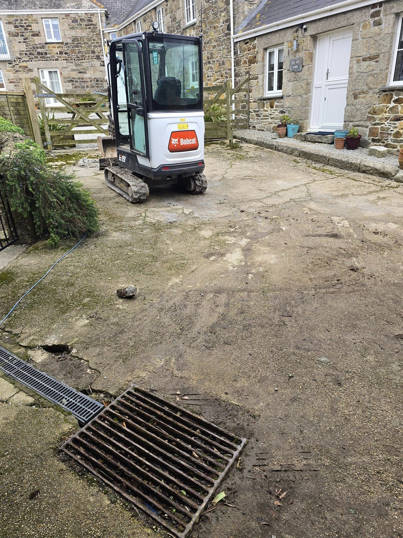 Mini digger working on a driveway site