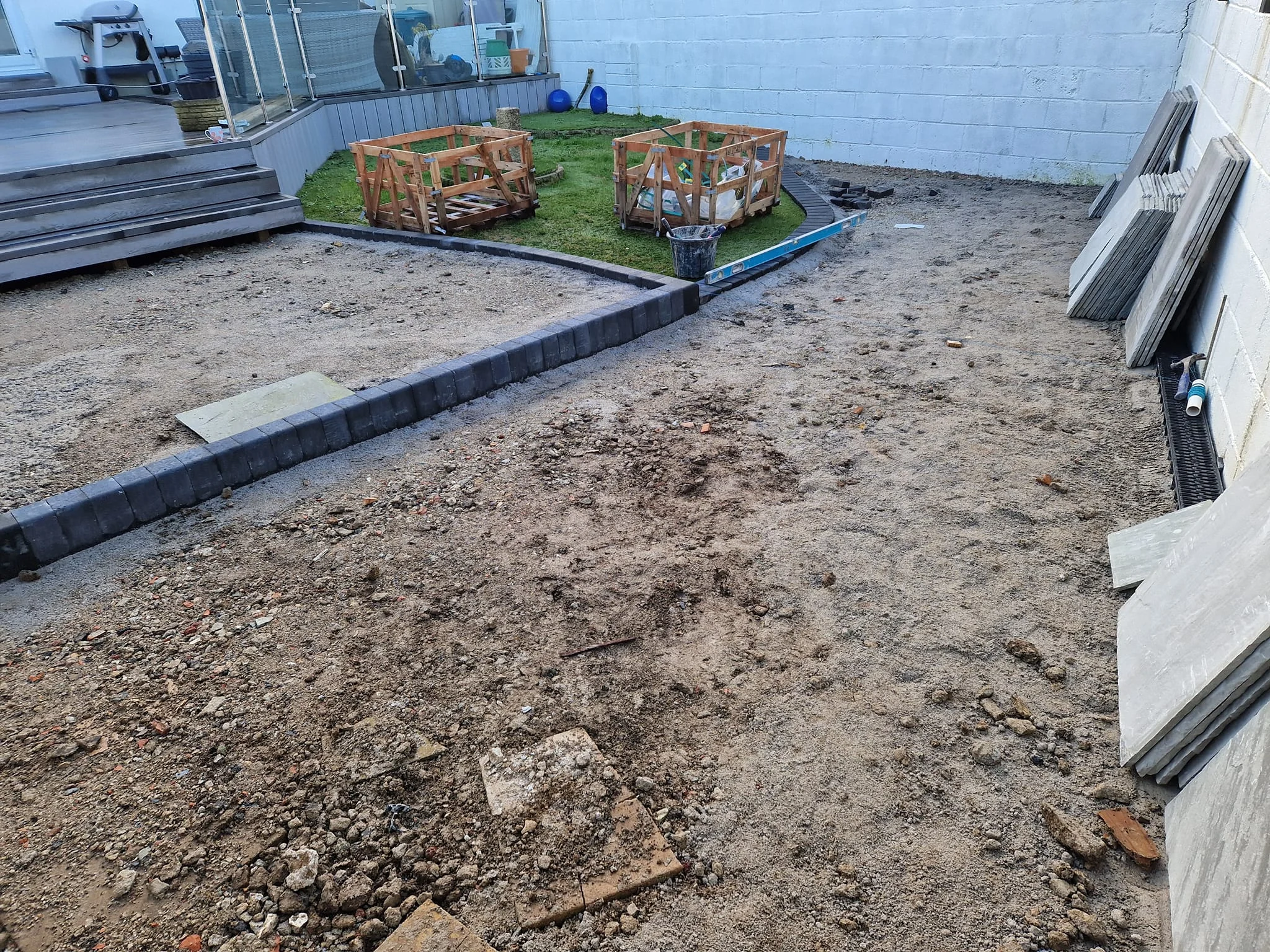 Prepared sub-base with edging set, ready for paving