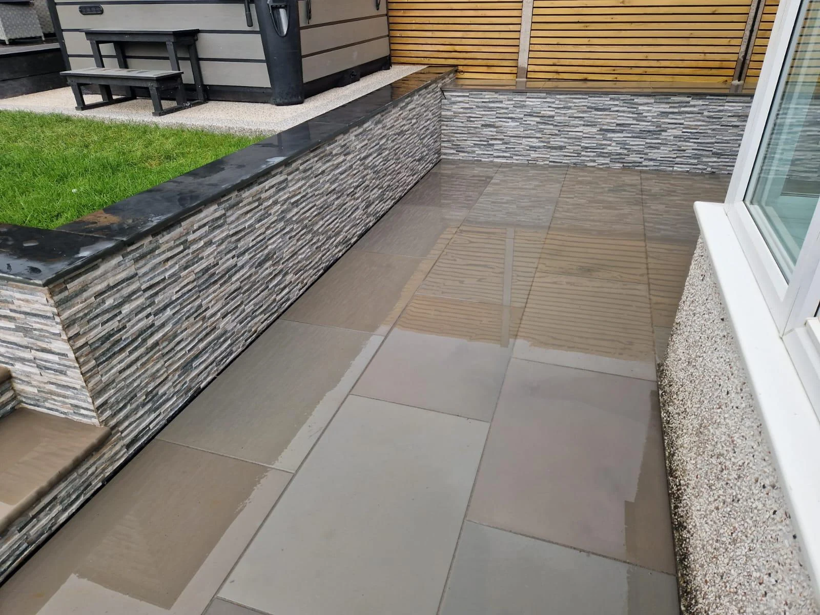 Porcelain patio with a clad retaining wall