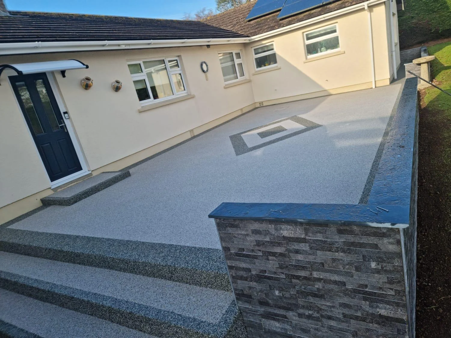 Resin patio with slate wall and steps
